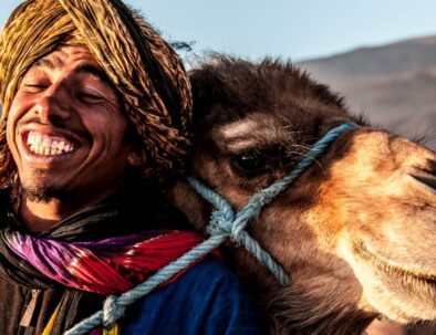 Portrait of Moroccan person hugging a camel