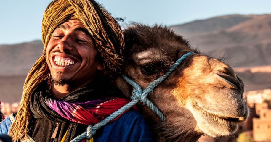 Portrait of Moroccan person hugging a camel