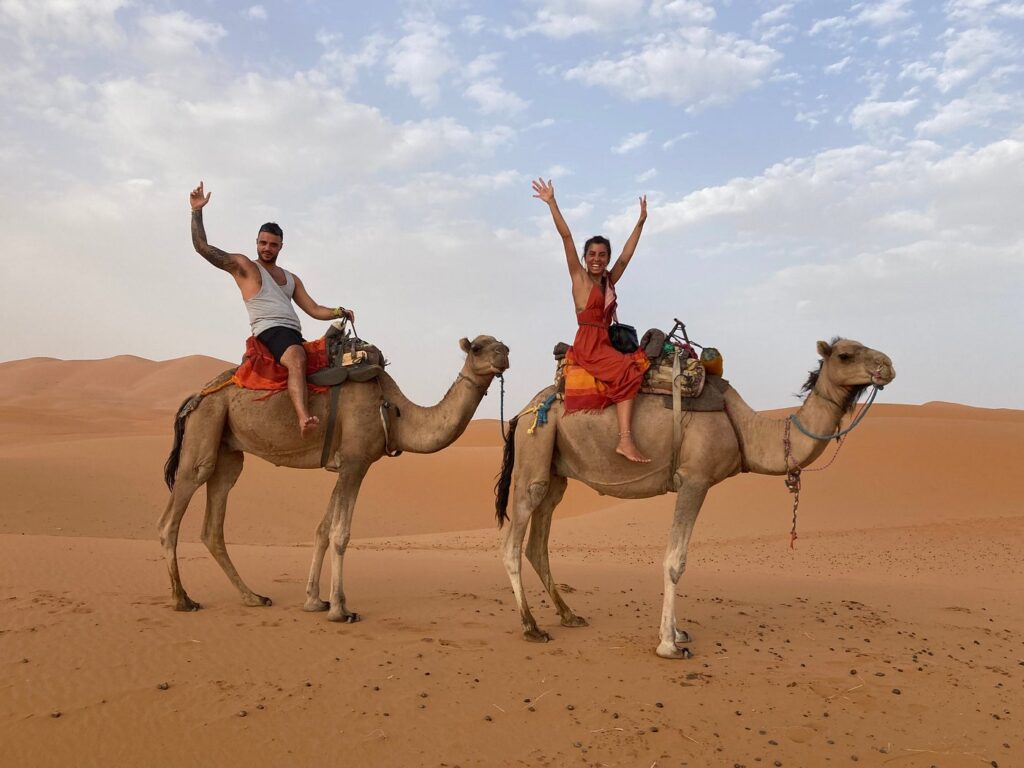 Camel ride of 2 people in the desert