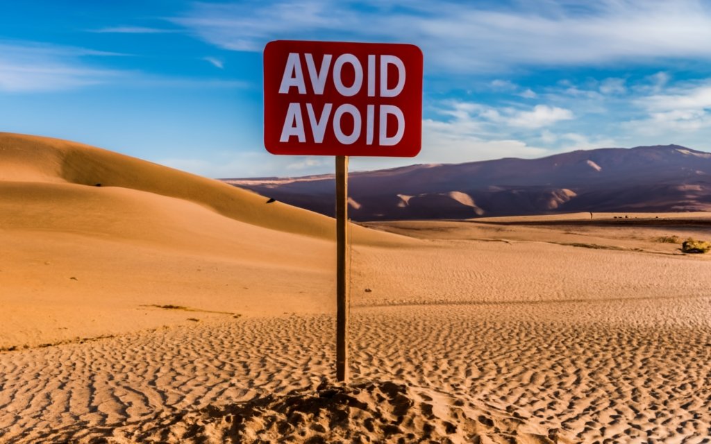 Sign saying "Avoid" in the desert