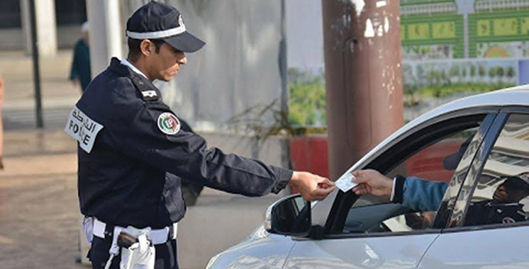 A Police Officer in Morocco handing documents.