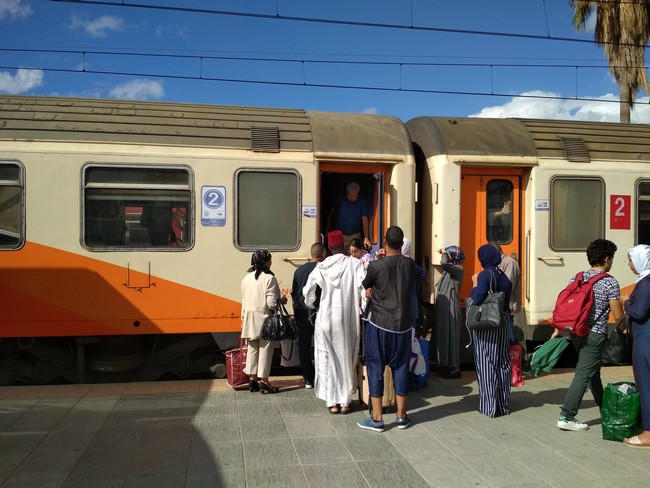People get on the train as it is one of the best ways to Travel around Morocco.