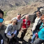Tourists exploring rocky Atlas landscapes with local driver and scenic mountain routes during the 3 days tour from marrakech to merzouga