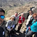 Tourists exploring rocky Atlas landscapes with local driver and scenic mountain routes during the 3 days tour from marrakech to merzouga
